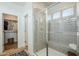 Glass shower with shower head and bench is steps away from a walk-in closet for convenience and relaxation at 630 W Laredo St, Chandler, AZ 85225
