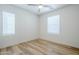 Bright bedroom with wood-look floors, ceiling fan and natural light from two windows at 630 W Laredo St, Chandler, AZ 85225