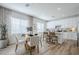 Bright dining area with a modern table set, wood floors, and a view into the kitchen, perfect for Gathering meals at 630 W Laredo St, Chandler, AZ 85225