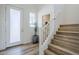 Welcoming entryway features modern wood-look staircase, light-filled window, and bright white door at 630 W Laredo St, Chandler, AZ 85225