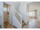 Hallway with staircase leading upstairs, complemented by wood-look floors, white trim, and bright white walls at 630 W Laredo St, Chandler, AZ 85225