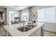 Bright kitchen island features a stainless steel sink and quartz countertops at 630 W Laredo St, Chandler, AZ 85225