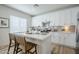 Well-lit kitchen with white cabinets, stainless steel appliances, and a central island with seating at 630 W Laredo St, Chandler, AZ 85225