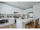 Bright kitchen featuring white cabinetry, stainless steel appliances, and an island with bar seating at 630 W Laredo St, Chandler, AZ 85225