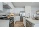 Spacious kitchen equipped with stainless steel appliances, white cabinets, and a long island at 630 W Laredo St, Chandler, AZ 85225