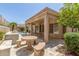 Covered patio with outdoor kitchen, travertine tile, a stone table, and a peek at the pool at 6528 W Via Montoya Dr, Glendale, AZ 85310