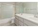 Bathroom featuring double sinks, grey cabinetry, a tiled floor, and a glass shower at 6528 W Via Montoya Dr, Glendale, AZ 85310