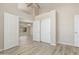 This bedroom features wood-look floors, a ceiling fan, and french doors to another room at 6528 W Via Montoya Dr, Glendale, AZ 85310