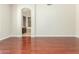 Bedroom featuring wood floors and an archway to a bathroom area at 6528 W Via Montoya Dr, Glendale, AZ 85310