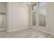 Bright bedroom featuring wood-look floors, neutral walls, ceiling fan and large windows at 6528 W Via Montoya Dr, Glendale, AZ 85310