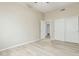 Bedroom featuring hardwood floors, a ceiling fan, and closet doors at 6528 W Via Montoya Dr, Glendale, AZ 85310