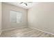 Bedroom featuring a ceiling fan, hardwood floors, and a window with blinds at 6528 W Via Montoya Dr, Glendale, AZ 85310