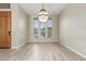 Bright dining room with wood floors and natural light streaming through large windows at 6528 W Via Montoya Dr, Glendale, AZ 85310