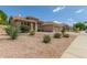 Single-story home featuring mature landscaping, a beige facade, and tile roof at 6528 W Via Montoya Dr, Glendale, AZ 85310