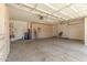 A spacious three-car garage offers an abundance of storage with overhead lighting and coated concrete floors at 6528 W Via Montoya Dr, Glendale, AZ 85310