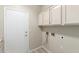 Functional laundry room featuring ample storage space and washer/dryer hookups at 6528 W Via Montoya Dr, Glendale, AZ 85310