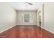 Open living space with wood floors, a window with blinds, and a ceiling fan at 6528 W Via Montoya Dr, Glendale, AZ 85310