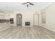 Open concept living area features a fireplace, wood floors, and seamless flow into the kitchen at 6528 W Via Montoya Dr, Glendale, AZ 85310
