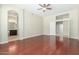 Main bedroom boasting wood floors, a ceiling fan, and an ensuite bathroom at 6528 W Via Montoya Dr, Glendale, AZ 85310