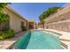 Inviting backyard pool with travertine surround and lush landscaping, providing a tranquil retreat at 6528 W Via Montoya Dr, Glendale, AZ 85310