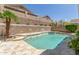 Sparkling backyard pool with stone patio and a privacy wall at 6528 W Via Montoya Dr, Glendale, AZ 85310