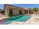 Backyard pool with travertine surround and covered patio, providing a perfect outdoor oasis at 6528 W Via Montoya Dr, Glendale, AZ 85310