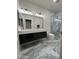 Modern bathroom featuring dual vanity, marble floors, and glass shower at 6821 W Donald Dr, Glendale, AZ 85310