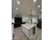 Spacious kitchen island with wine fridge and an open-concept design with the living room at 6821 W Donald Dr, Glendale, AZ 85310