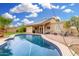 The yard features a pool with a pool cleaner, chairs, solar panels, and a covered patio for relaxing outdoors at 7229 S Butte Ave, Tempe, AZ 85283