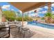 A gorgeous backyard features a refreshing pool with a seating area under a covered patio for outdoor relaxation at 7229 S Butte Ave, Tempe, AZ 85283
