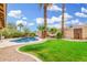 The backyard features a pool, a hammock strung between two trees, and a grassy area for a tranquil outdoor space at 7229 S Butte Ave, Tempe, AZ 85283