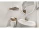 Cozy bathroom boasts a round mirror, floating shelves and ample towels at 7229 S Butte Ave, Tempe, AZ 85283