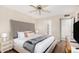Comfortable bedroom features a king bed, ceiling fan, and ensuite bathroom at 7229 S Butte Ave, Tempe, AZ 85283