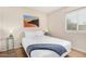 Neutral bedroom has a queen bed with bedside tables and vibrant decor at 7229 S Butte Ave, Tempe, AZ 85283