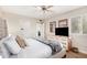 Relaxing bedroom features a ceiling fan, natural light, and a dresser with a TV at 7229 S Butte Ave, Tempe, AZ 85283