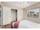 Bright bedroom features a queen bed, closet, and a sunlit window at 7229 S Butte Ave, Tempe, AZ 85283