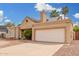 Home exterior with two-car garage, neutral stucco, well-kept yard, and ample driveway parking at 7229 S Butte Ave, Tempe, AZ 85283