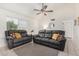 Inviting living room with plush seating, a ceiling fan, and neutral decor throughout the space at 7229 S Butte Ave, Tempe, AZ 85283