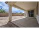 Covered patio overlooking a spacious backyard and block fence at 7531 W Odeum Ln, Phoenix, AZ 85043