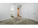Bedroom with plush carpet, white walls, a walk-in closet and en-suite bathroom at 7531 W Odeum Ln, Phoenix, AZ 85043