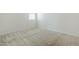 Bright bedroom with neutral carpet, white walls, and natural light from the window at 7531 W Odeum Ln, Phoenix, AZ 85043