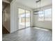 Dining area with a modern light fixture, sliding glass doors to the patio, and wood-look tile flooring at 7531 W Odeum Ln, Phoenix, AZ 85043