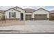 Charming single-story home with a three-car garage, desert landscaping, and a beautiful tile roof at 7531 W Odeum Ln, Phoenix, AZ 85043