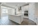 Open-concept kitchen with a large island, stainless appliances, and views of the dining area at 7531 W Odeum Ln, Phoenix, AZ 85043