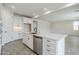Well-equipped kitchen with stainless steel appliances, white cabinets, a large island, and sleek hardware at 7531 W Odeum Ln, Phoenix, AZ 85043