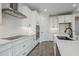 Contemporary kitchen with white cabinets, stainless appliances, and an island featuring a sink at 7531 W Odeum Ln, Phoenix, AZ 85043