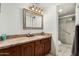 This bathroom features a vanity with granite counters and a shower with glass doors at 7625 E Camelback Rd # B124, Scottsdale, AZ 85251