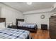 This bedroom has hardwood floors, two beds, and a wooden dresser and nightstand at 7625 E Camelback Rd # B124, Scottsdale, AZ 85251