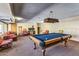 Spacious game room with a pool table, seating area and stylish lighting at 7625 E Camelback Rd # B124, Scottsdale, AZ 85251