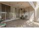 Relaxing covered patio with tile flooring, outdoor seating, and sliding glass doors with decorative shutters at 7625 E Camelback Rd # B124, Scottsdale, AZ 85251
